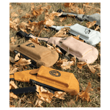 Yellow, tan, beige, and white crossbody bags with front pockets resting on dry grass and autumn leaves.