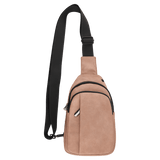 Dusty pink crossbody sling bag with a black strap, front zipper pockets, and a grommet hole on a white background.