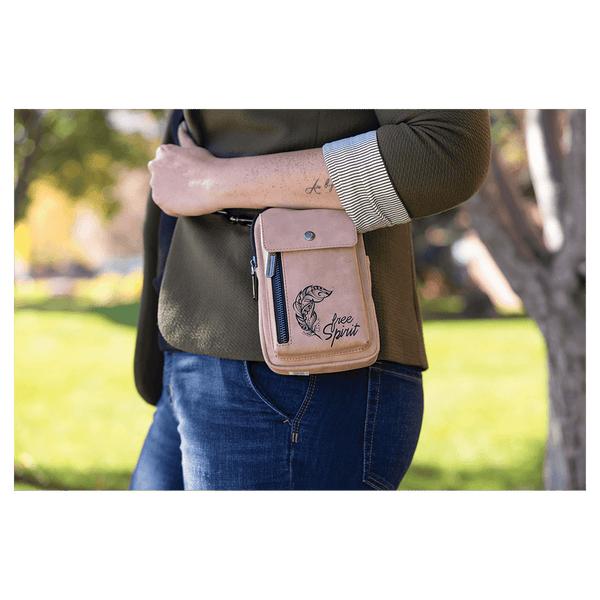 Pink bag with flap pocket, snap hardware, and side zipper worn at the hip by a person outdoors in a green park.
